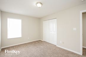 Noblesville house for rent - a bedroom with a closet and a door and a window