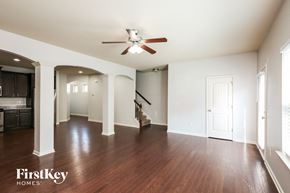 Woodstock house for rent - A spacious room with wooden floors and a ceiling fan.