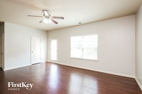 Woodstock house for rent - A spacious room with a ceiling fan and wooden flooring.