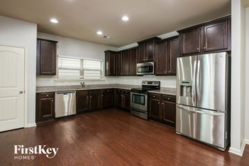 Woodstock house for rent - A kitchen with dark brown cabinets and stainless steel appliances.