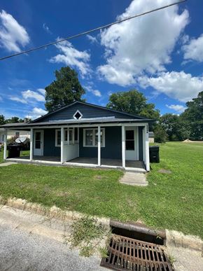 Stantonsburg apartment for rent - A small blue house with a porch and a white door.