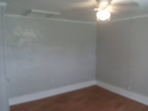 Stantonsburg apartment for rent - the corner of a room with white walls and a wooden floor
