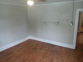 Stantonsburg apartment for rent - an empty room with a wooden floor and a white wall with a shelf