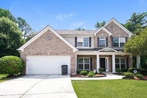 Atlanta house for rent - a brick house with a white garage door in front of it