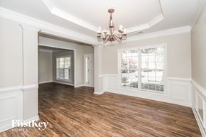 Atlanta house for rent - a dining room with a chandelier and a window