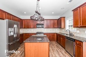 Atlanta house for rent - a kitchen with wooden cabinets and stainless steel appliances