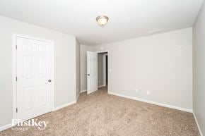 Atlanta house for rent - a master bedroom with carpet and a door to a closet