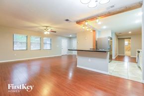Sarasota house for rent - an empty living room and kitchen with wood flooring