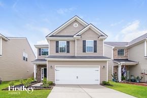 Summerville house for rent - a beige and brown house with a white garage door