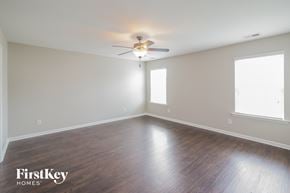 Summerville house for rent - a living room with wood floors and a ceiling fan