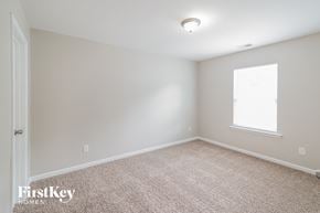 Summerville house for rent - a bedroom with a carpeted floor and a window