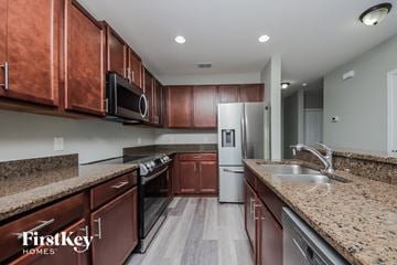 Davenport house for rent - a kitchen with granite counter tops and wooden cabinets