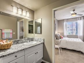 San Diego apartment for rent - a bathroom with a sink and a mirror and a bedroom