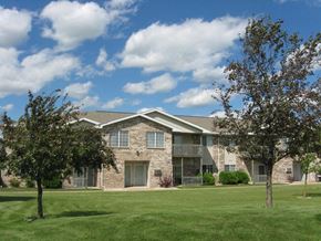 Appleton apartment for rent - an apartment building with a lawn and trees