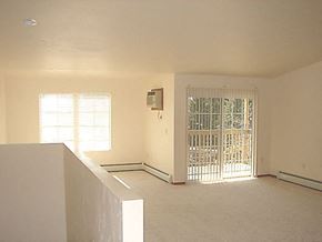 Neenah apartment for rent - an empty living room with a door and a window