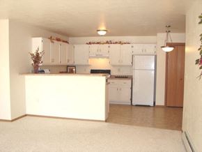 Neenah apartment for rent - an empty kitchen with white cabinets and a white refrigerator