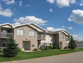Appleton apartment for rent - an apartment building with green grass and trees