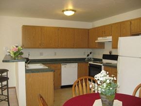 Appleton apartment for rent - a kitchen with wooden cabinets and a red table and chairs