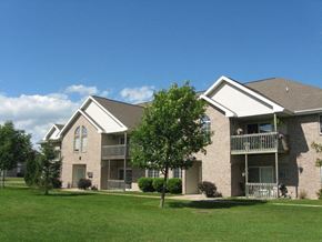 Appleton apartment for rent - an apartment building with green grass and trees