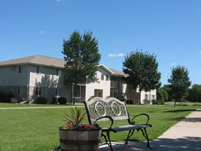 Neenah apartment for rent - a park bench sitting in front of a house