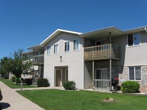 Neenah apartment for rent - an apartment building with a porch and a lawn