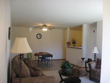 Neenah apartment for rent - a living room with furniture and a ceiling fan