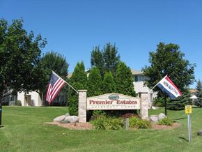 Neenah apartment for rent - a sign for premier estates in front of a building