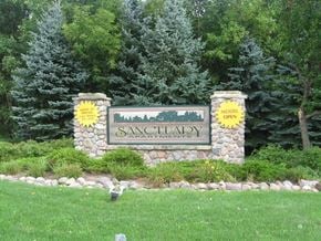 Appleton apartment for rent - a sign for sansonary park in front of trees