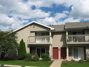 Appleton apartment for rent - an apartment building with a red door and a balcony