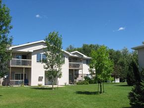 Appleton apartment for rent - a white apartment building with trees in front of it