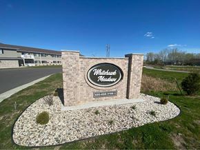 Appleton apartment for rent - a sign in front of a building on the side of a road