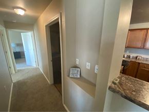 Appleton apartment for rent - a view of a hallway with a kitchen and a hallway mirror