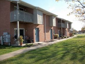 Green Bay apartment for rent - a brick apartment building with a balcony and a sidewalk