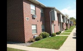 Green Bay apartment for rent - a row of brick apartment buildings next to a sidewalk