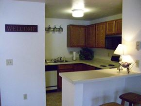 Green Bay apartment for rent - an empty kitchen with a welcome sign on the wall