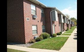 Green Bay apartment for rent - a row of brick apartment buildings next to a sidewalk