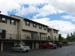 West Bend apartment for rent - a building with cars parked in front of it