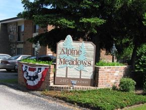 South Milwaukee apartment for rent - a sign for alpine meadows in front of a building