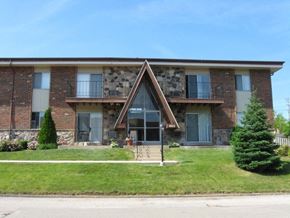 South Milwaukee apartment for rent - a building with a triangular sign in front of it