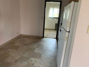 St. Francis apartment for rent - an empty room with a white refrigerator in it