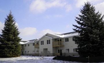 West Bend apartment for rent - a large white house with two trees in front of it