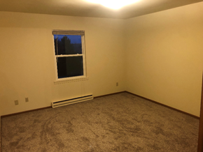 West Bend apartment for rent - A room with a carpeted floor and a window.