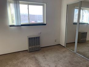 St. Francis apartment for rent - a room with a radiator and a window and a mirror