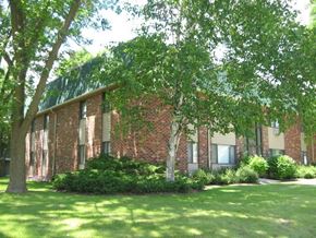 Menomonee Falls apartment for rent - a large brick building with trees in front of it