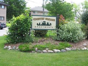 Menomonee Falls apartment for rent - a sign for county square apartments in a garden
