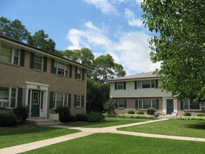 Menomonee Falls apartment for rent - an apartment building with a green lawn and sidewalk