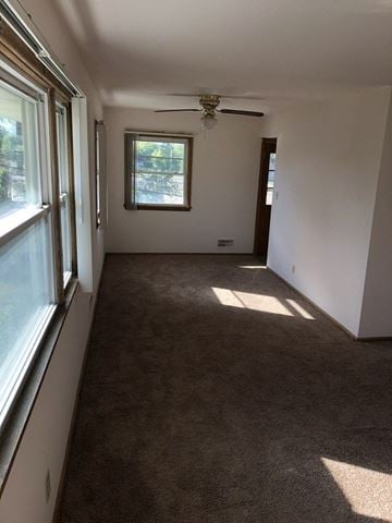 Menomonee Falls apartment for rent - a living room with carpet and a window and a ceiling fan