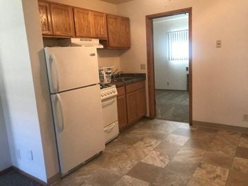 St. Francis apartment for rent - a kitchen with a refrigerator and a stove and a door