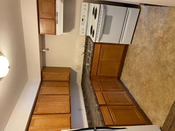 Waukesha apartment for rent - a small kitchen with a stove and a refrigerator