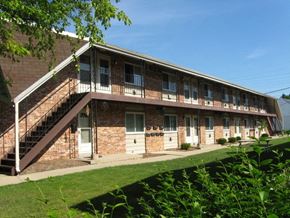 St. Francis apartment for rent - a brick apartment building with stairs and a balcony